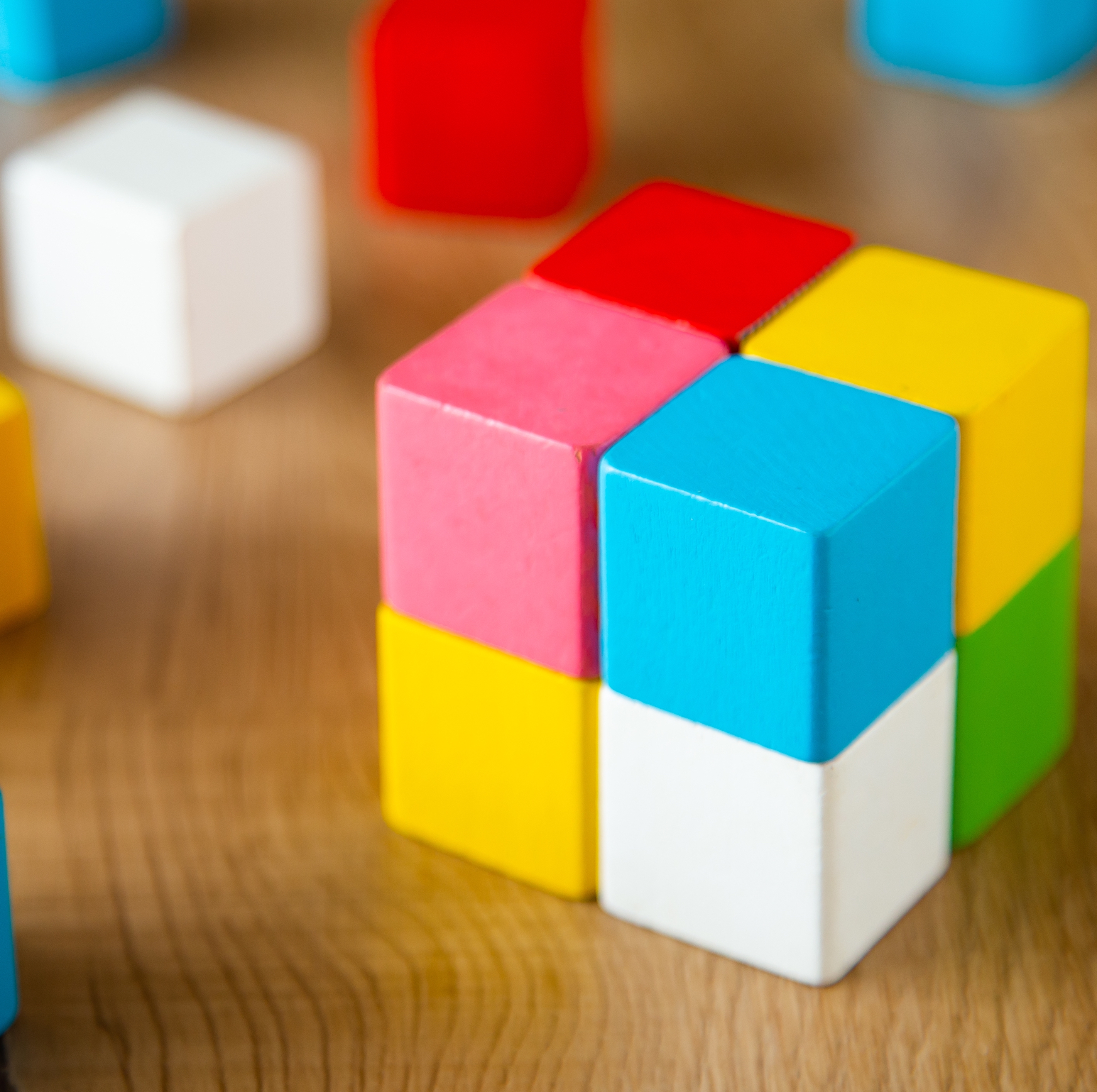 Colorful wooden blocks stacked into a block